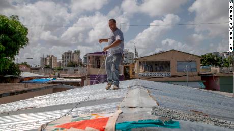 Jorge Ortiz was tying down his in San Juan, Puerto Rico, Tuesday in preparation for Tropical Storm Dorian.