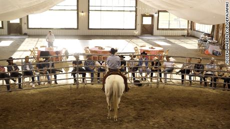 Horse whisperer Grant Golliher leads a demonstration wtih executives.