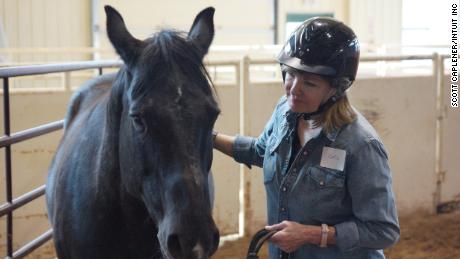 Cece Morken, an executive vice president at Intuit, learning to lead a horse in the round pen.