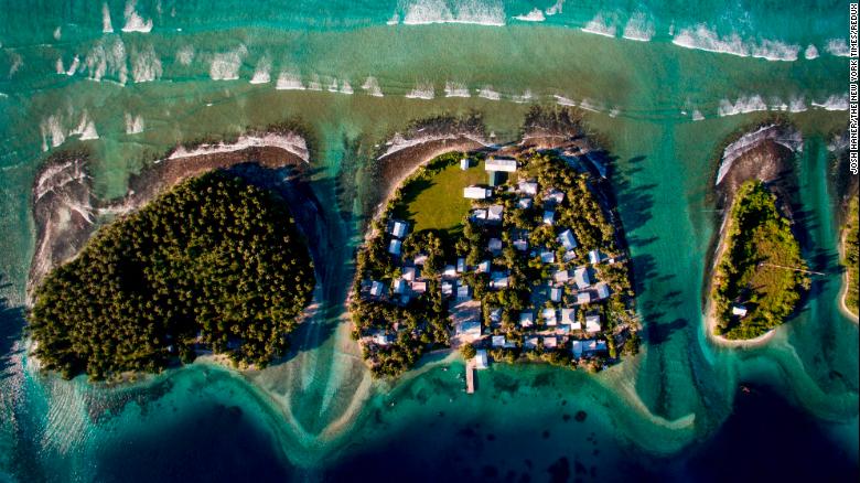 This aerial photo shows Ejit, an islet in the Marshall Islands, in 2015. The islands are threatened by rising seas. &quot;I flew a drone above the island showing just how precarious its location is: Homes clinging to the edge of an eroding coastline as unrelenting waves chisel away at what remains,&quot; said &lt;a href=&quot;http://www.joshhaner.com/&quot; target=&quot;_blank&quot;&gt;Josh Haner,&lt;/a&gt; a photographer with The New York Times. &quot;After I saw what was happening on Ejit, I realized that climate change is not something nebulous that will only start affecting us in the future, but rather something happening right now. Residents are being forced to make the most difficult decision: Do they stay and build sea walls to buy some more time, or do they relocate?&quot;