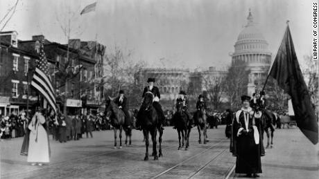 Women suffragists march down Pennsylvania Avenue with the US Capitol in background in 1913. 
