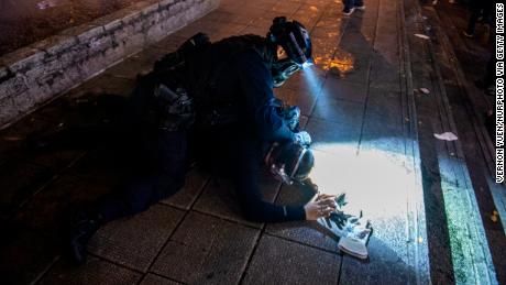 A police officer from the Special Tactical Squad, nicknamed the &quot;raptors,&quot; arrests a protester on August 11.