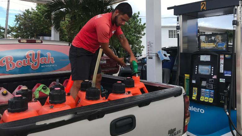 Mathew Cabral fills gas cans before the storm.