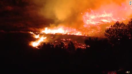 The fire was moving toward homes when a police officer on patrol saw it, police say. 