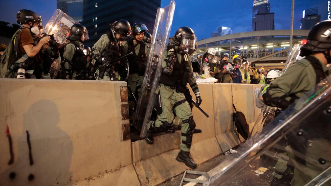 Police officers move forward during clashes with protesters on August 31.