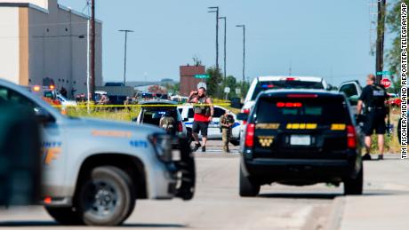 CORRECTS THE NAME OF THE SOURCE TO THE MIDLAND REPORTER-TELEGRAM - Odessa and Midland police and sheriff's deputies surround the area behind Cinergy in Odessa, Texas, Saturday, Aug. 31, 2019, after reports of shootings. Police said there are "multiple gunshot victims" in West Texas after reports of gunfire on Saturday in the area of Midland and Odessa. (Tim Fischer/Midland Reporter-Telegram via AP)