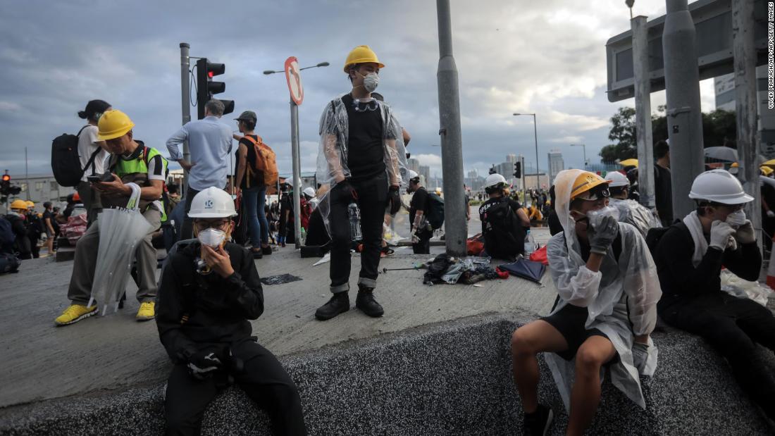 Protesters stand behind barricades outside the government headquarters the morning of July 1.