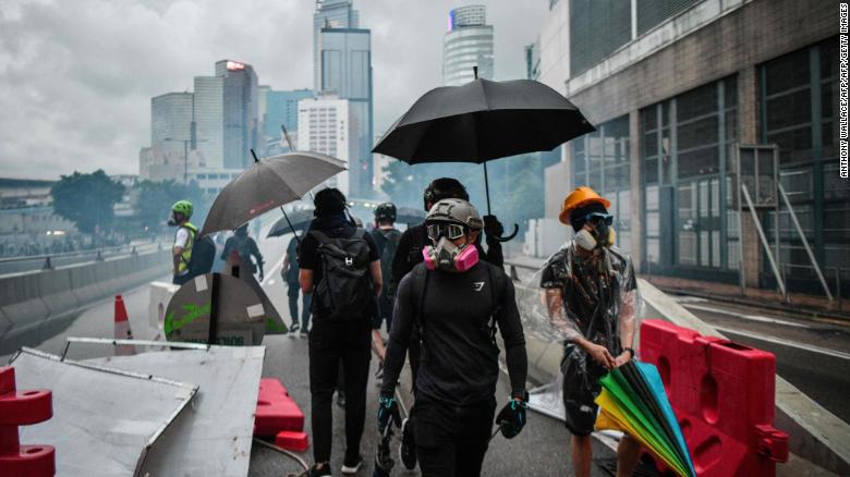 Protesters gather on a road as police fire tear gas outside the government headquarters in Hong Kong on August 31, 2019.