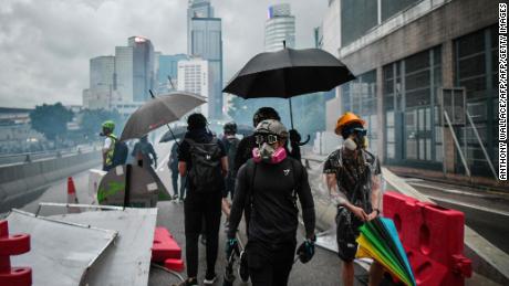 Protesters gather on a road as police fire tear gas outside the government headquarters in Hong Kong on August 31, 2019.