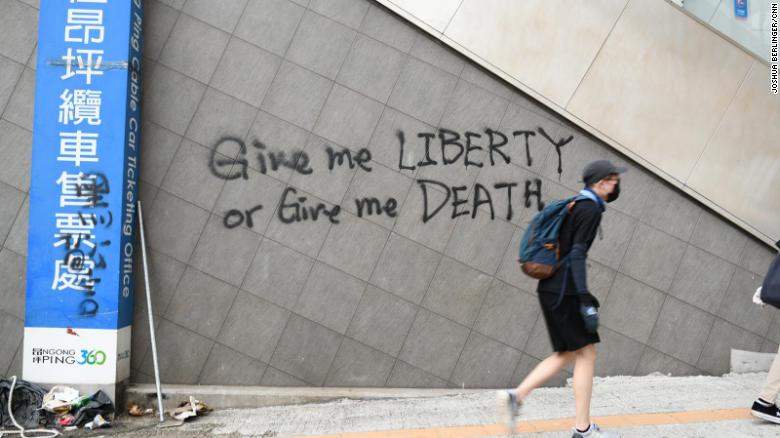 Graffiti on a wall in Tung Chung, where protesters fled after disrupting transport to and from Hong Kong airport.