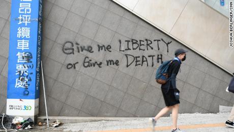 Graffiti on a wall in Tung Chung, where protesters fled after disrupting transport to and from Hong Kong airport.