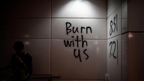 Graffiti outside Hong Kong&#39;s Tung Chung subway station reads &quot;burn with us.&quot;