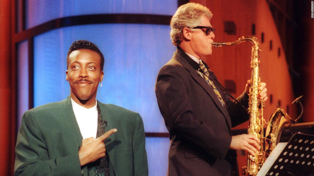 Talk show host Arsenio Hall gestures approvingly as Clinton plays the saxophone during a taping of &quot;The Arsenio Hall Show&quot; in 1992. Clinton was running for president at the time.