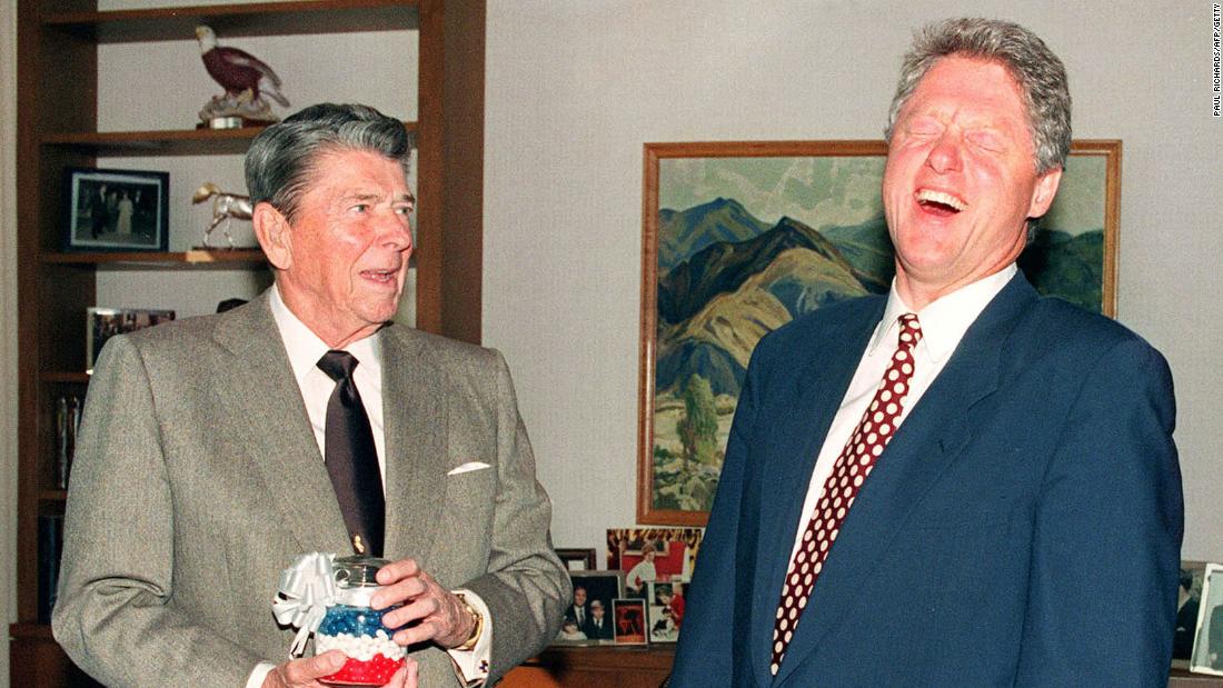 Former President Ronald Reagan presents Clinton with a jar of red, white and blue jelly beans in Los Angeles in November 1992. Reagan said they kept him from smoking cigarettes.