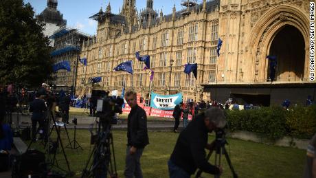 Journalists are seen at the temporary media broadcast tents near the Houses of Parliament in central London on September 4, 2019. - British Prime Minister Boris Johnson lost a crucial parliamentary vote on his Brexit strategy on Tuesday after members of his own Conservative Party voted against him, opening the way for possible early elections. The ruling Conservative party lost its working majority in parliament on Tuesday after one of its MPs switched to the anti-Brexit Liberal Democrats and, a few hours later, it expelled 21 MPs from the party for voting against the government. (Photo by Oli SCARFF / AFP)        (Photo credit should read OLI SCARFF/AFP/Getty Images)