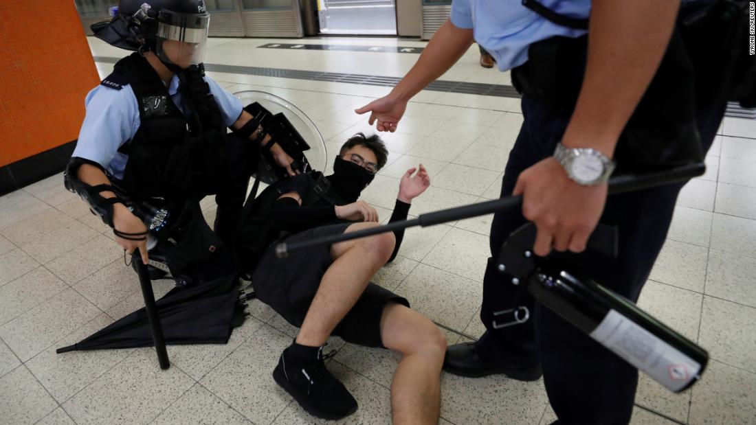 A protester is detained by police at the Po Lam Mass Transit Railway station on Thursday, September 5.