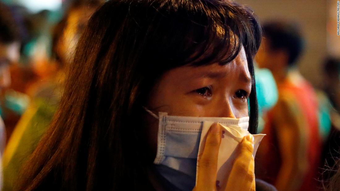 A woman gets emotional on September 4 while paying her respects to protesters who were injured a few days earlier.