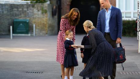 Britain&#39;s Princess Charlotte of Cambridge, accompanied by her father, Britain&#39;s Prince William, Duke of Cambridge, her mother, Britain&#39;s Catherine, Duchess of Cambridge, is greeted by Helen Haslem, head of the lower school (CR) on her arrival for her first day of school at Thomas&#39;s Battersea in London on September 5, 2019.