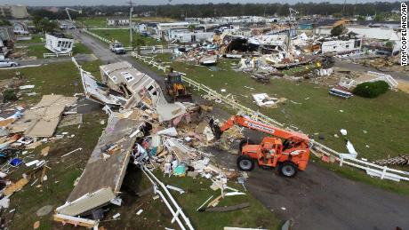 CORRECTS YEAR TO 2019-Emerald Isle town employees work to clear the road after a tornado hit Emerald Isle N.C. as Hurricane Dorian moved up the East coast on Thursday, Sept. 5, 2019. (AP Photo/Tom Copeland)