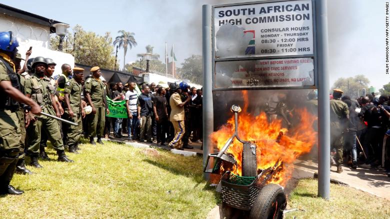 Zambia's university students burn the sign outside the South African Embassy in Lusaka.