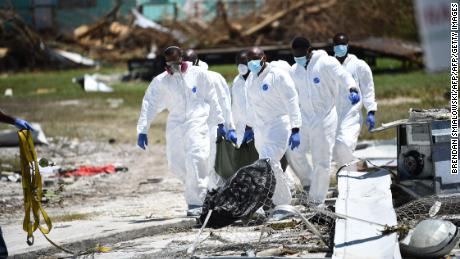 Rescue workers recover the body of a victim of Hurricane Dorian on Thursday in Marsh Harbour, Great Abaco Island.