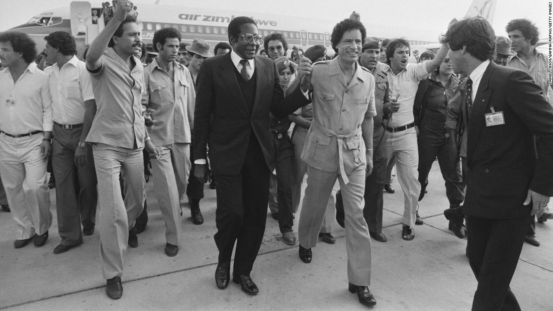 Mugabe holds hands with Libyan leader Moammar Gadhafi at the Organization of African Unity summit in August 1982.