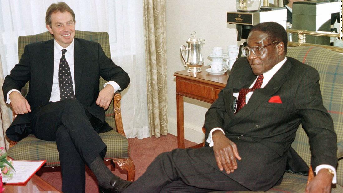 British Prime Minister Tony Blair talks with Mugabe in October 1997, before the start of the Commonwealth Heads of Government meeting.