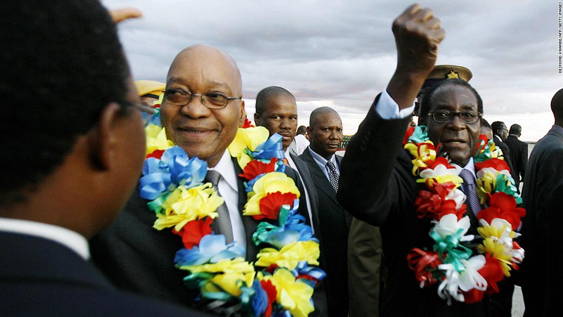 South African President Jacob Zuma walks with Mugabe at Harare International Airport in March 2010.