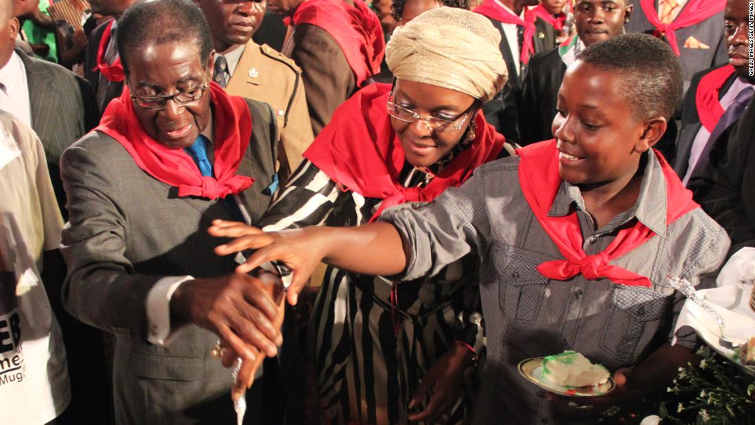 Mugabe cuts his birthday cake with his wife, Grace, and son Bellarmine Chatunga during celebrations in Harare in February 2011. Mugabe was turning 87.