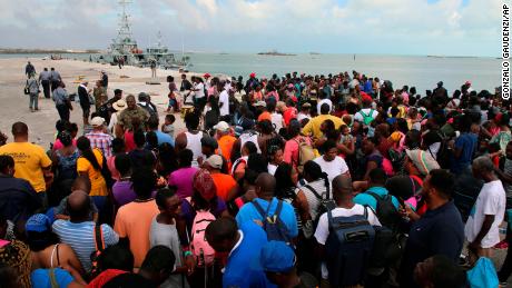 People wait in Marsh Harbour Port to be evacuated to Nassau, in Abaco, Bahamas, Friday, Sept. 6, 2019. The evacuation is slow and there is frustration for some who said they had nowhere to go after the Hurricane Dorian splintered whole neighborhoods. (AP Photo/Gonzalo Gaudenzi)