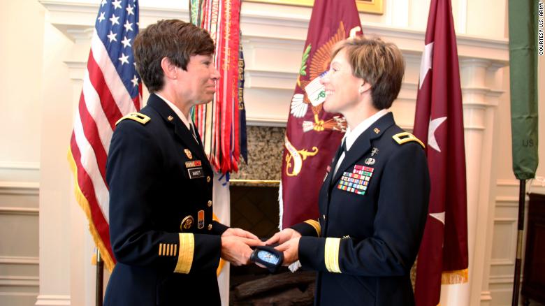 Maj. Gen. Maria Barrett presenting Brig. Gen. Paula Lodi a beret with one-star rank insignia as a tribute to the history of women serving in the Army and the historic moment of sisters serving together as General Officers.