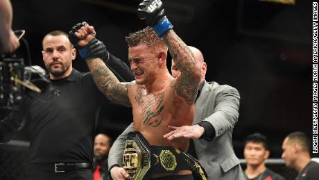 Dustin Poirier celebrates after recieving the title belt from UFC President Dana White.