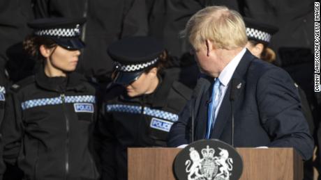 Britain&#39;s Prime Minister Boris Johnson reacts as an officer fell unwell during his speech.
