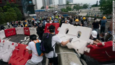 Protesters move barricades to block a street during the June 12 protest.