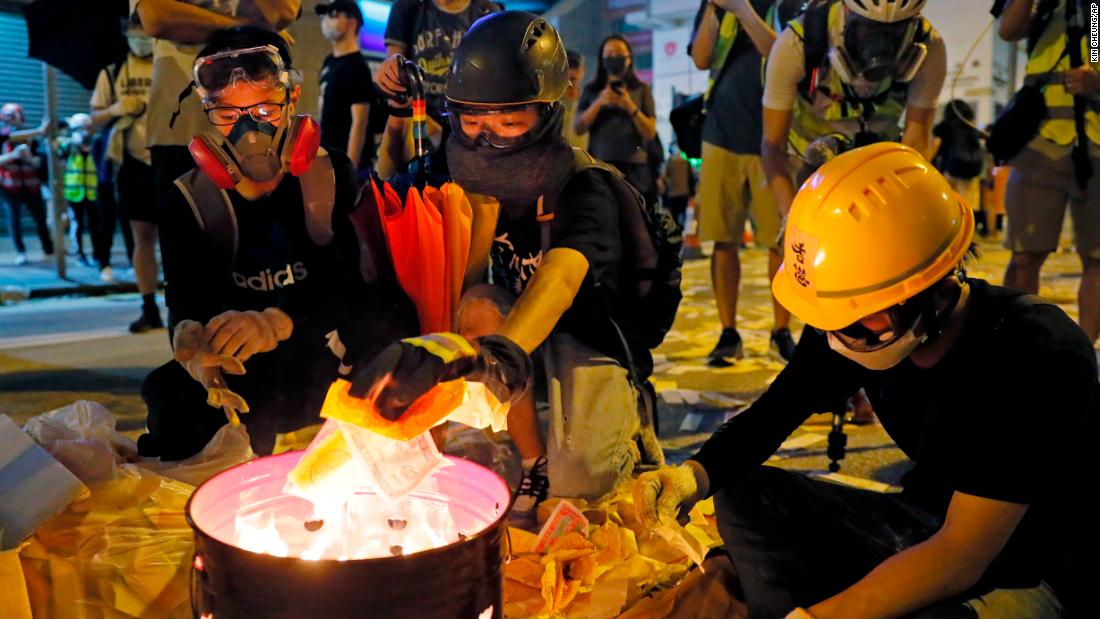 Protesters burn paper money to pay their respects to injured protesters.