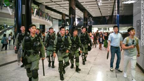 Riot police patrol the Hong Kong MTR underground metro station in Hong Kong on September 7.