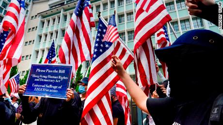 Protesters wave US national flags as they march to the US consulate in Hong Kong on September 8.