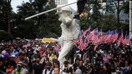 Protesters wave US national flags as they march from Chater Garden to the US Consulate in Hong Kong on September 8.