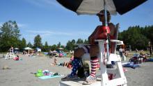 Lifeguard Luke Orot watches over swimmers at Jewel Lake on a hot July 4 in Anchorage.