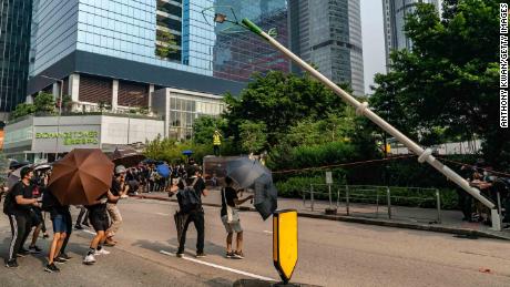 Protesters attempt to pull down a &quot;smart&quot; lamp post during an anti-government rally in Hong Kong on August 24.