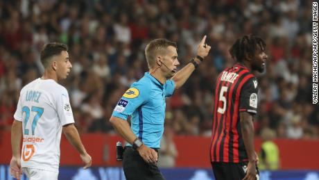 Referee Clement Turpin suspends the game between  Nice and Olympique de Marseille (OM) after persistent homophobic chants and the display of a disparaging banner. 