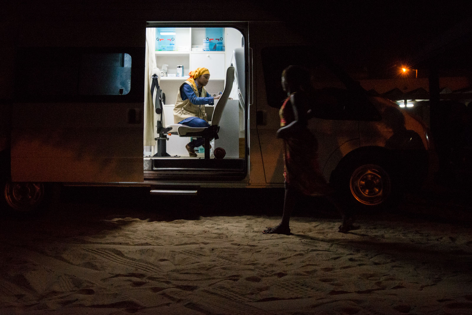 A clandestine sex worker approaches the Enda Santé mobile clinic for a check-up with a doctor