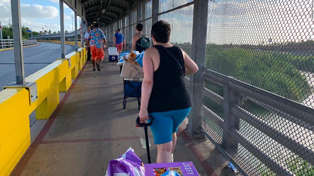 Volunteers organized by "Full Frontal with Samantha Bee" staffer Ana Bretón, walk across the Texas-Mexico border to bring food to migrants in tent camps. 