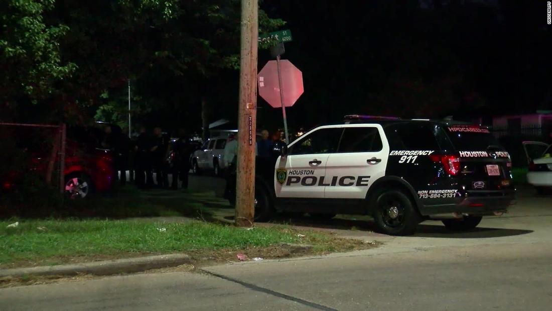 Houston police at the scene of gun battle in which officer was wounded and suspect fatally shot. 