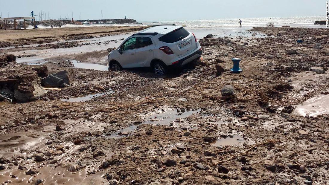 A car lies in the mud after a flood in San Jose, Almeria, in south-eastern Spain on Friday.