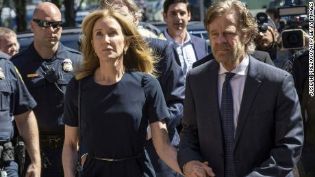 Actress Felicity Huffman, escorted by her husband William H. Macy, makes her way to the entrance of the John Joseph Moakley United States Courthouse September 13, 2019 in Boston, where she will be sentenced for her role in the College Admissions scandal. - Huffman, one of the defendants charged in the college admissions cheating scandal, is scheduled to be sentenced for paying $15,000 to inflate her daughters SAT scores, a crime she said she committed trying to be a good parent. (Photo by Joseph Prezioso / AFP)        (Photo credit should read JOSEPH PREZIOSO/AFP/Getty Images)