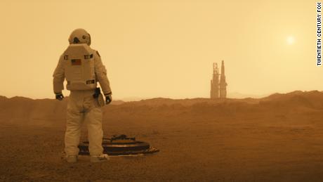 Brad Pitt as Roy McBride surveys the Martian landscape in &quot;Ad Astra.&quot;