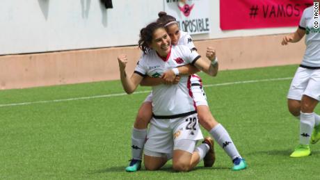 Two CD Tacon players celebrate after scoring a goal. 