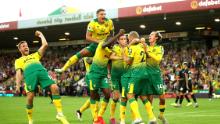 Teemu Pukki of Norwich City celebrates with teammates after scoring his team's third goal during the Premier League match between Norwich City and Manchester City at Carrow Road on September 14, 2019.