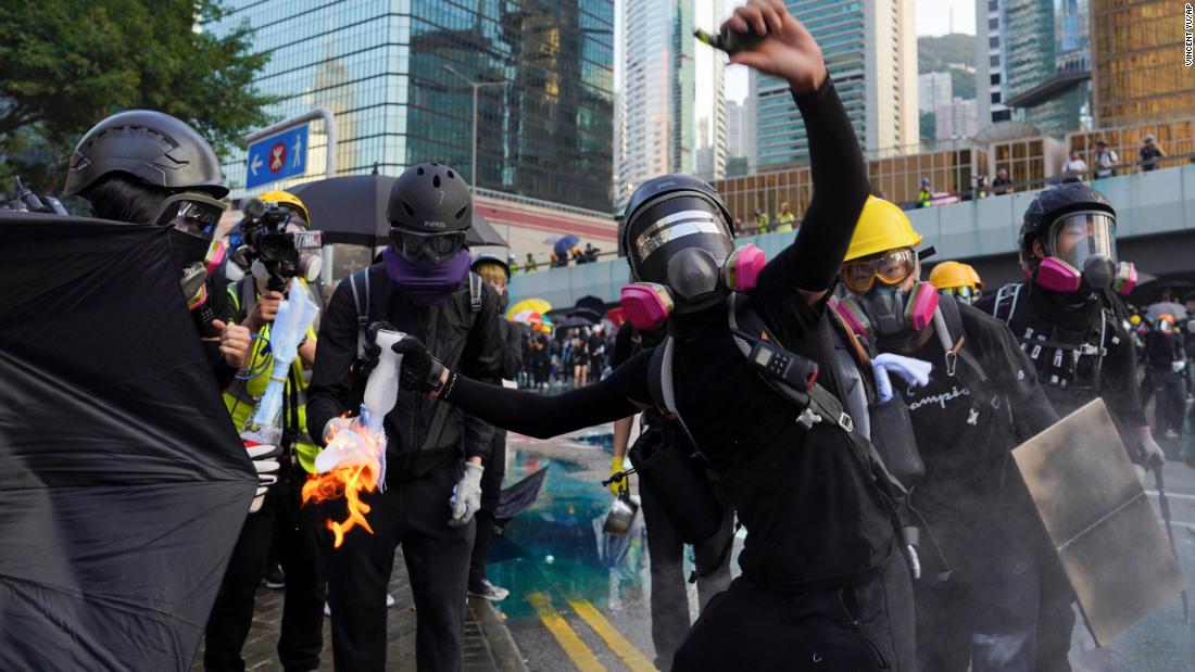 An anti-government protester throws a Molotov cocktail during a demonstration near Central Government Complex in Hong Kong on Sunday, September 15.